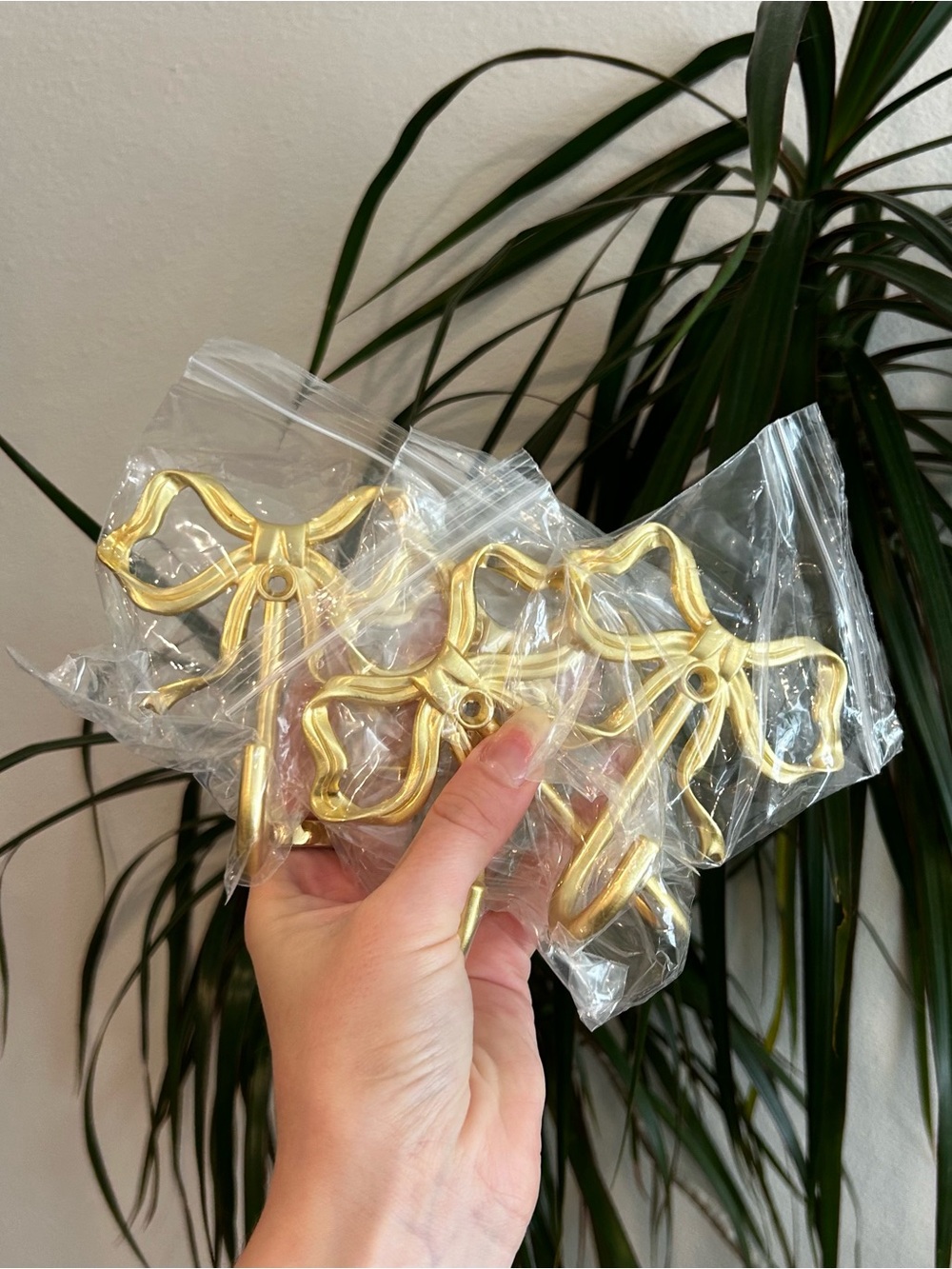 Gold bow shaped wall hooks. 4 hooks. New